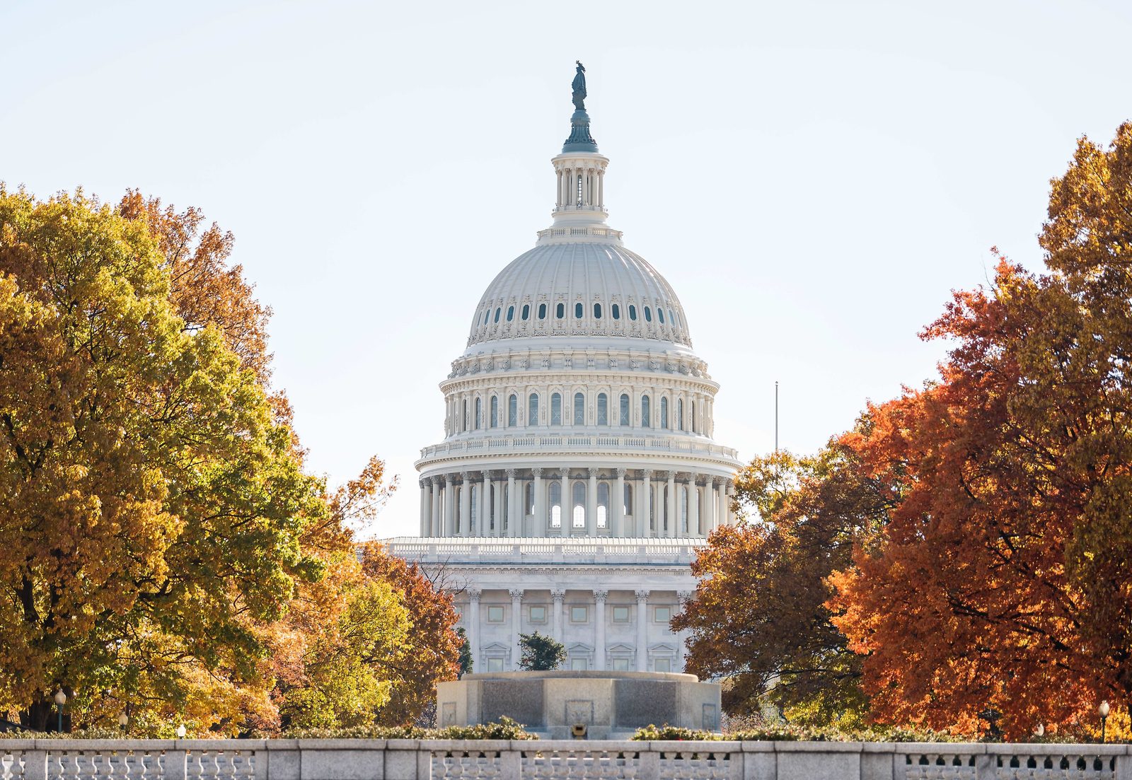 The U.S. Capitol dome framed by autumn trees